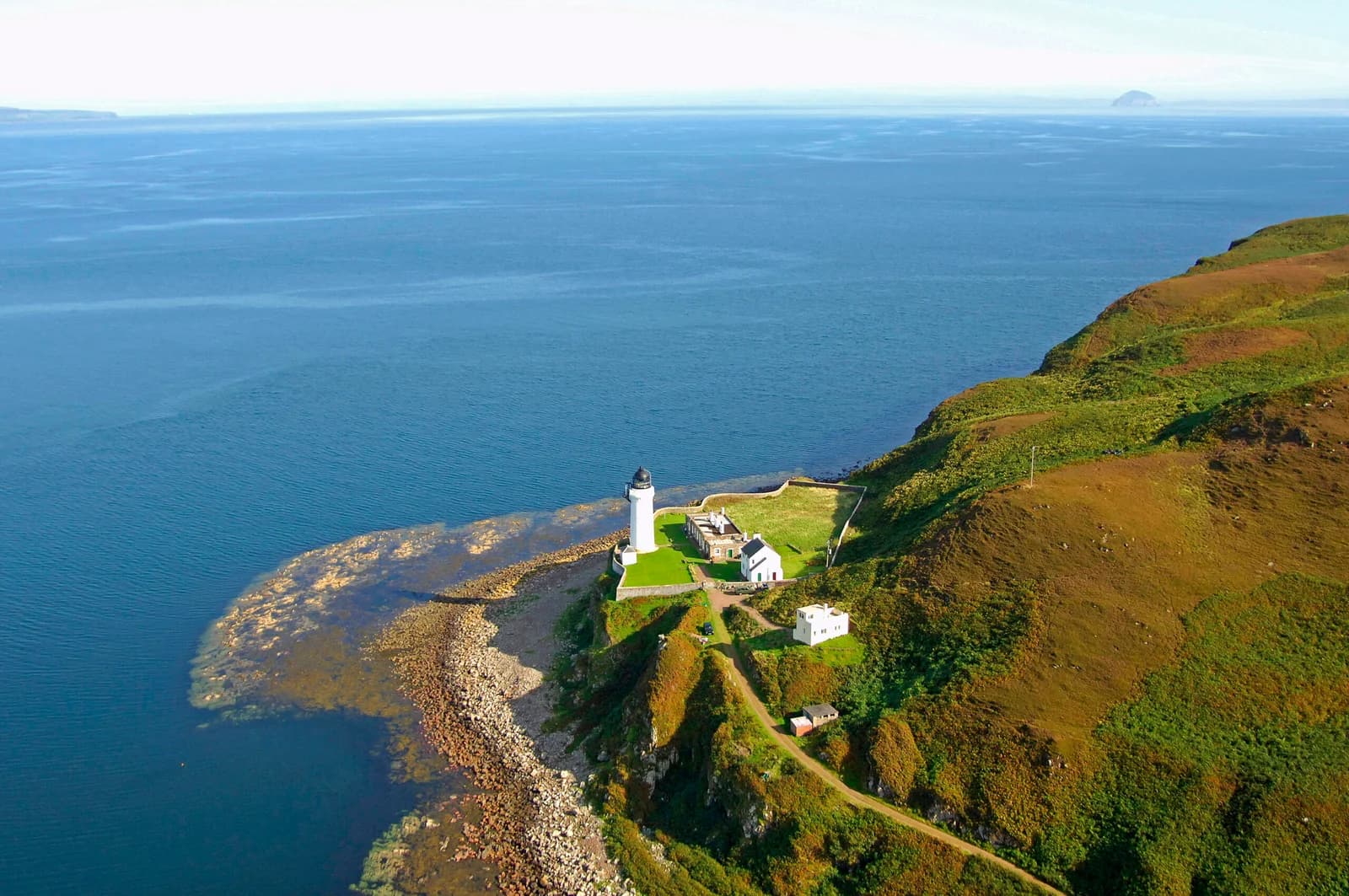 Aerial view of Davaar Island lighthouse and its rocky shoreline