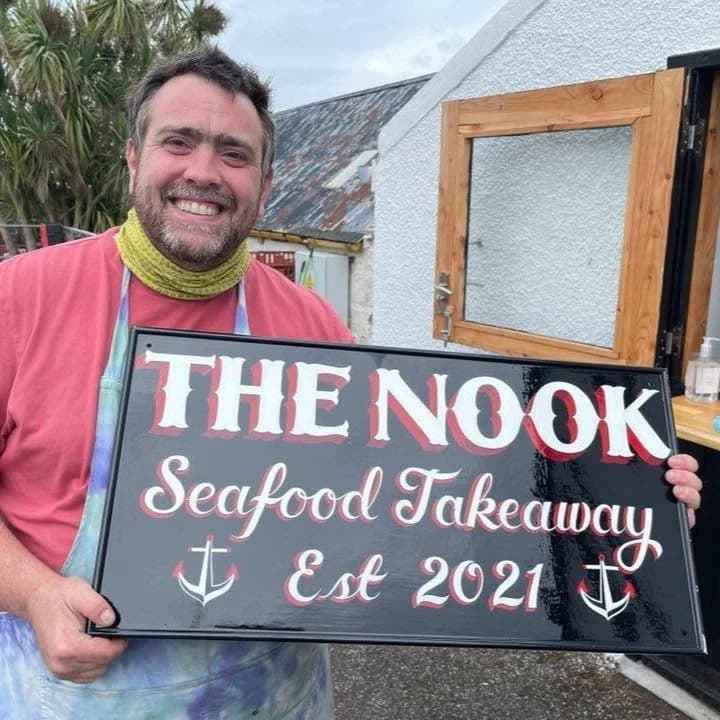 The Nook Seafood Takeaway on Gigha, with its sign outside the venue
