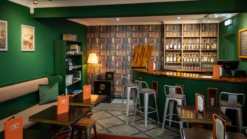 Green walls, tables and whisky shelves in the tasting room behind Cadenhead's Campbeltown shop