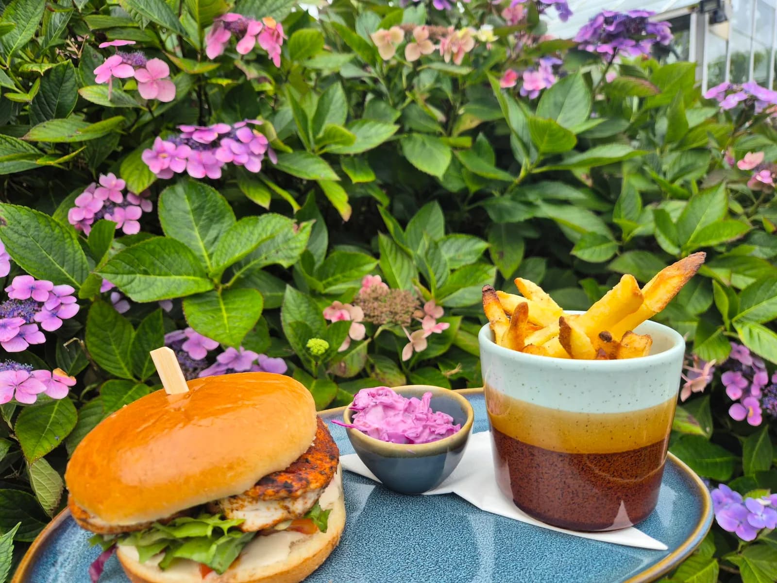 Burger, chips and slaw among the flowers at Glenbarr Stores