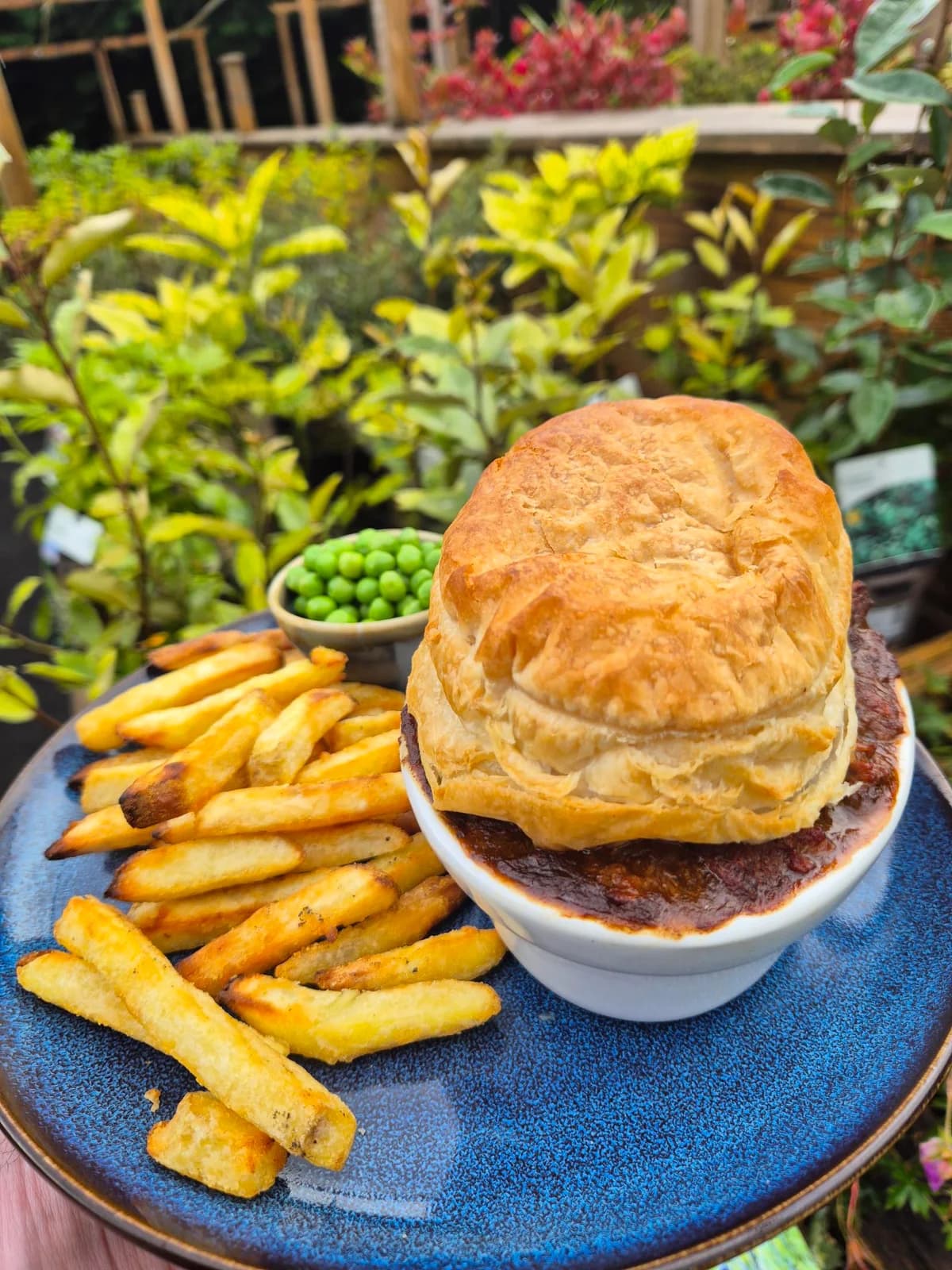 Golden pastry-topped pie with chips and peas at Glenbarr Stores