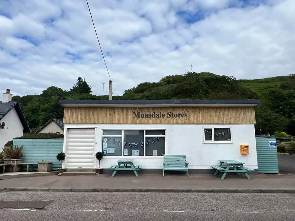 Muasdale Stores with timber signage, pale green benches and picnic tables