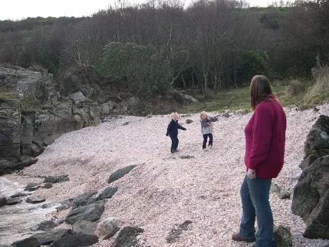 Visitors on the pale shell-covered shore at Shell Beach, Tarbert