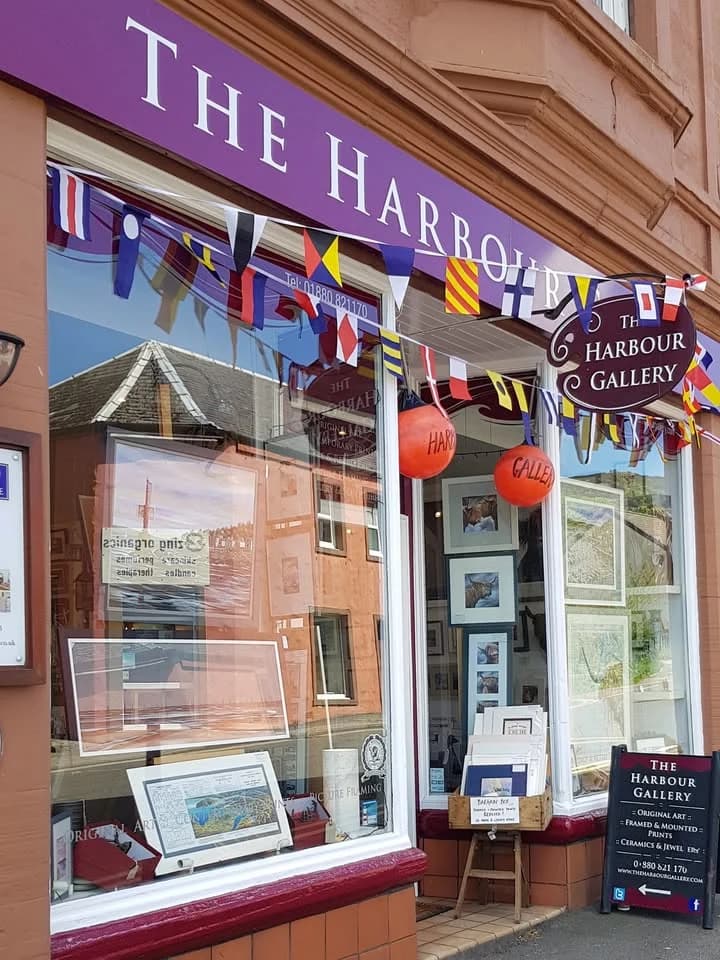 The Harbour Gallery shopfront in Tarbert, with artwork in the windows