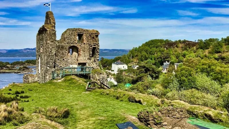 Tarbert Castle tower ruins on a sunny hillside
